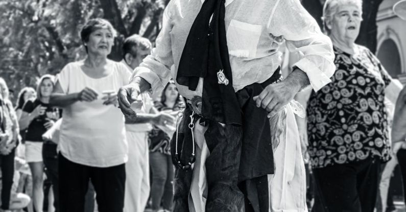 Parades - A man in a cowboy hat and hat walking down the street