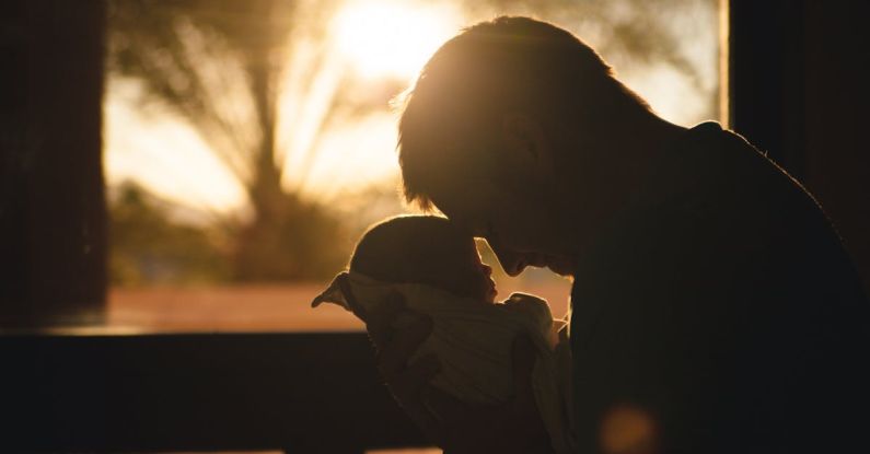 Moments - Man Carrying Baby Drawing Their Foreheads