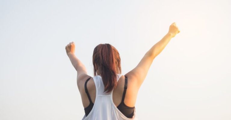 Wins - Woman Wearing Black Bra and White Tank Top Raising Both Hands on Top