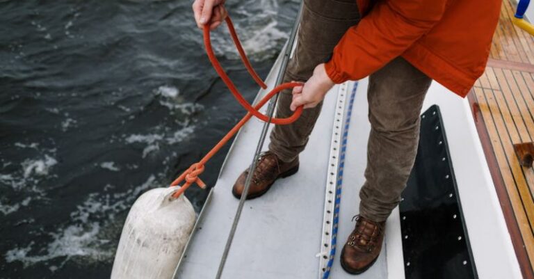 Releases - A Person in Red Jacket Holding the Rope of a White Buoy