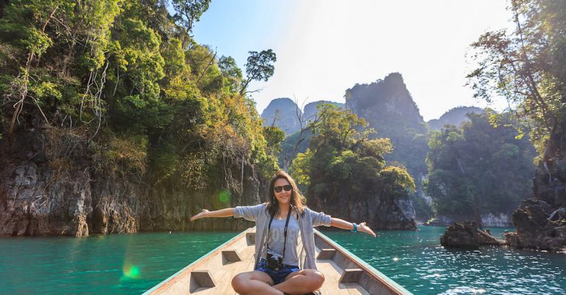 Tours - Photo of Woman Sitting on Boat Spreading Her Arms