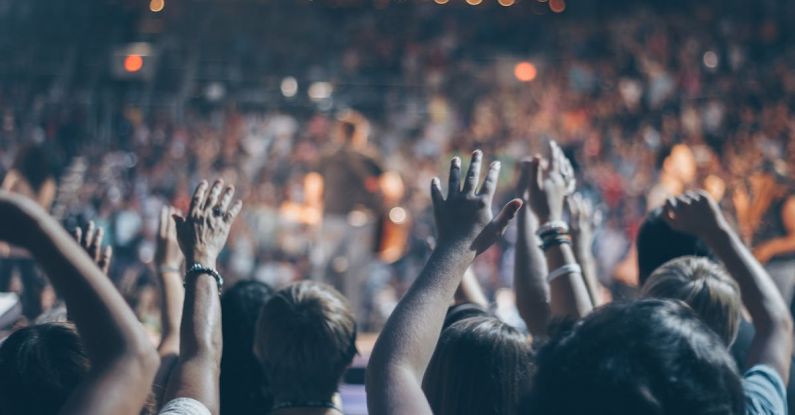 Concerts - Group of People Raise Their Hands on Stadium