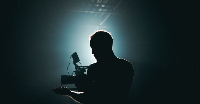 Premieres - Silhouette of Man Standing in Front of Microphone