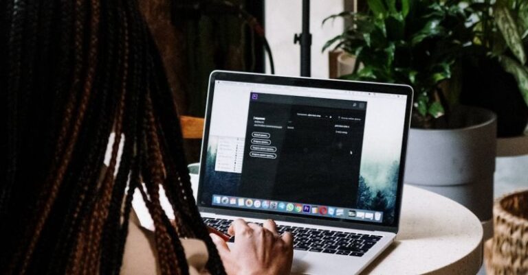 Premieres - Person Using Macbook Pro on Brown Wooden Table