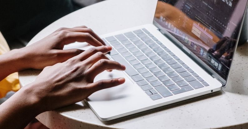 Premieres - Person Using Macbook Pro on Table