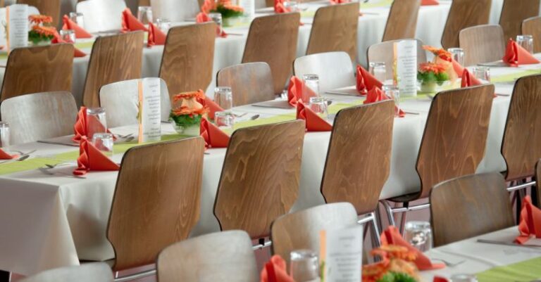 Events - Long Tables With White Cloths and Brown Chairs Formal Setting