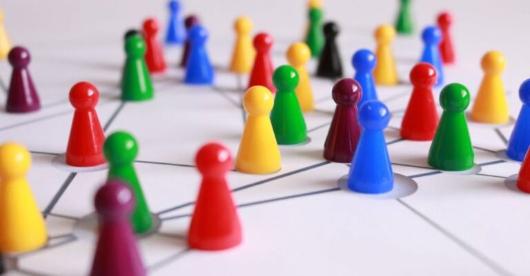 Teams - Close Up Photography of Yellow Green Red and Brown Plastic Cones on White Lined Surface