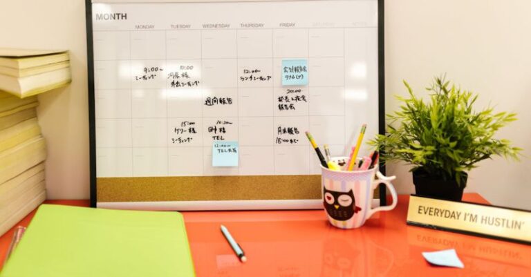 Schedules - A Desk Calendar with Notes and Post Its on Orange Desk