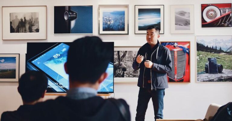 Speech - Man Beside Flat Screen Television With Photos Background