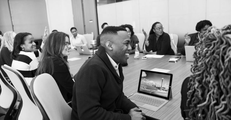 Conference - Group of People Sitting in Conference Table Laughing