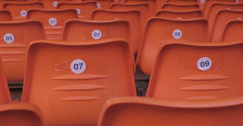 Venues - Orange seats in a stadium with numbers on them